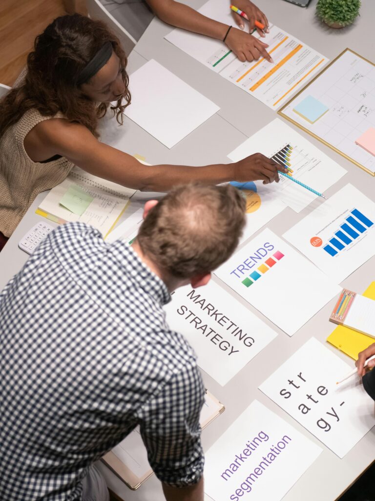 Team discussing marketing strategies in a modern office setting with charts and documents.